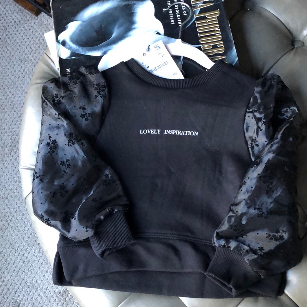 Zara’s black sweatshirt top